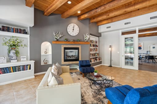 a living room with a fireplace and a large clock on the wall