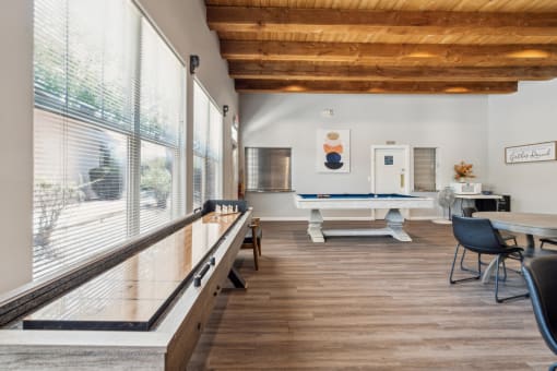 A room with a pool table and a billiard table.