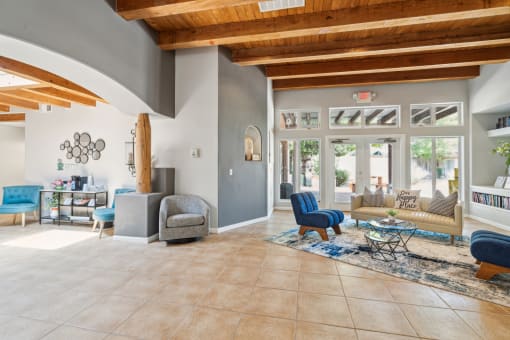 the living room of a house with blue chairs and couches