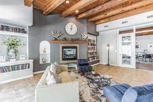 a living room with a couch and a clock on the wall
