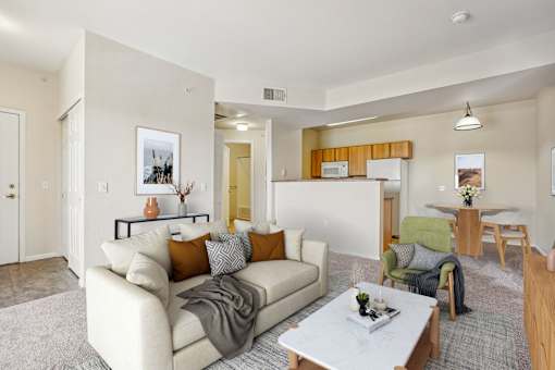 A living room with a white couch and a coffee table.