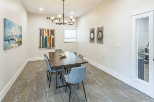 a dining room with a table and chairs and a window