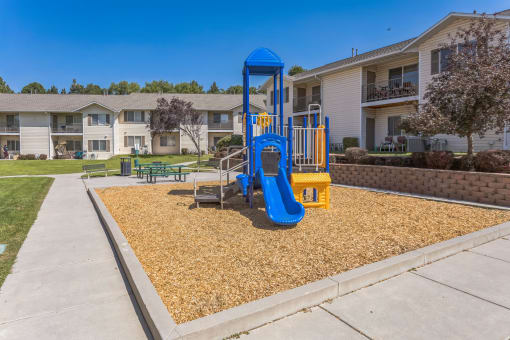 our playground is in front of our apartments with a blue swing set