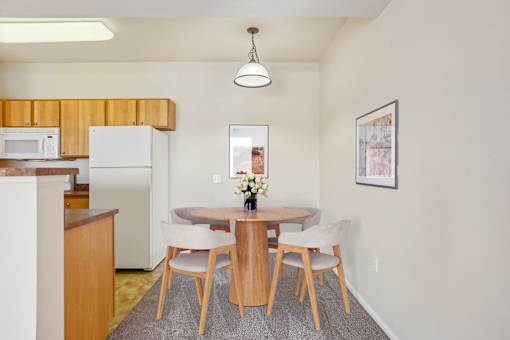 A dining room with a table and chairs.