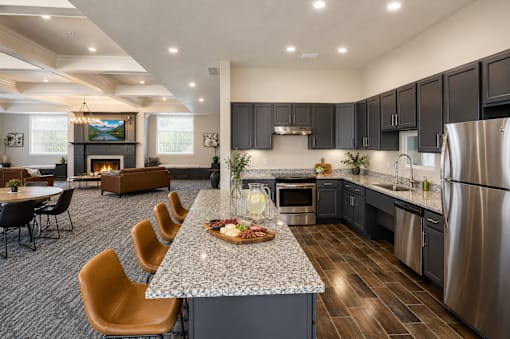 Open concept kitchen and living area with island seating at The Ellison Apartments, Layton, Utah