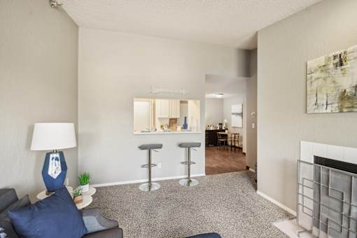 A living room with a grey couch and a blue lamp.