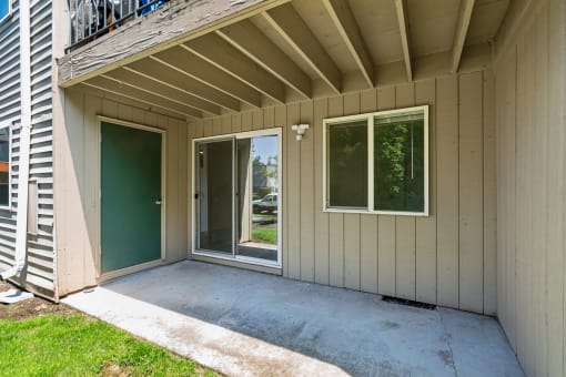 the screened in porch of a manufactured home with a sliding glass door