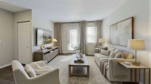 A well-lit, modern living room with a sofa, armchair, and coffee table at Arbors at Hickory Creek Apartments , University Park, IL, 60484