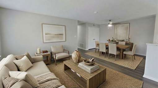 A living room with a couch, chairs, and a coffee table at Arbors at Hickory Creek Apartments , Apartments, University Park, IL