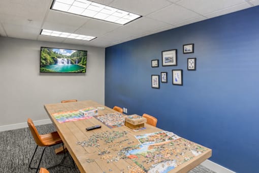 Community puzzle room with activity table at The Beckstead Apartments, South Jordan, Utah
