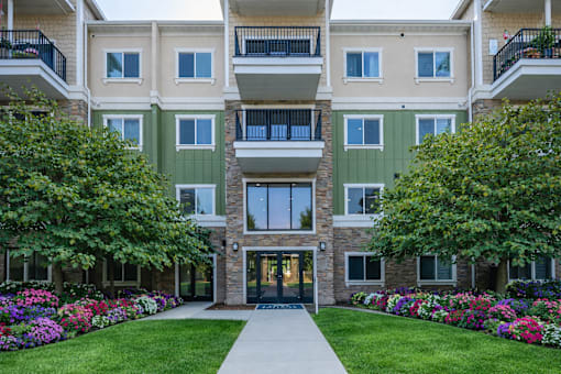 Modern apartment building exterior with landscaped courtyard at The Beckstead Apartments, Utah