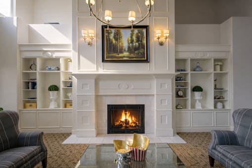 Clubhouse lounge with fireplace and built in shelving at The Beckstead Apartments, South Jordan, UT