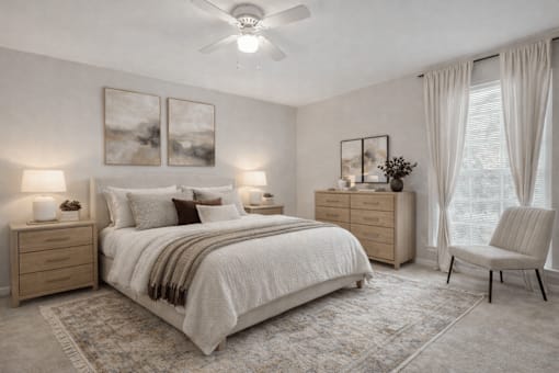 A bedroom with a large bed, a chair, and two lamps.