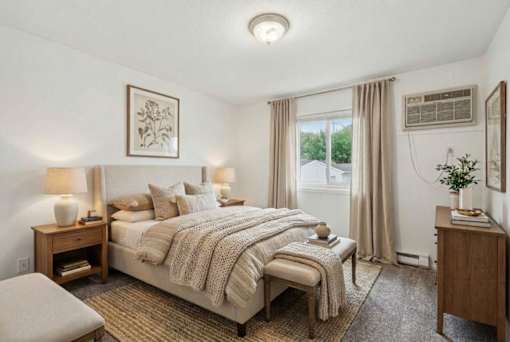 Cozy bedroom with neutral decor and natural light at Carver Ridge Townhomes Apartments, Chaska, Minnesota