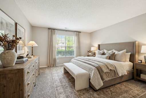 Spacious bedroom with neutral tones and large window at Delta Crossing Apartments, Charlotte, 28212