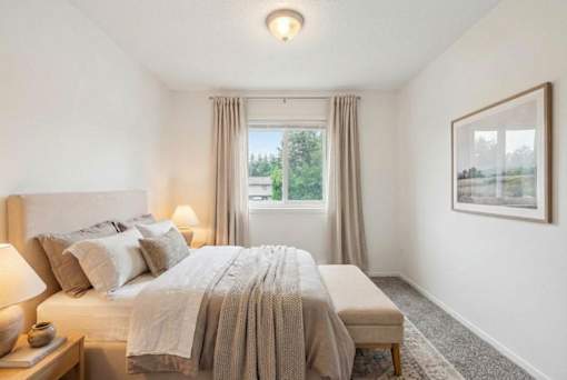 Bright bedroom with neutral tones and natural light at Carver Ridge Townhomes Apartments, Minnesota, 55318