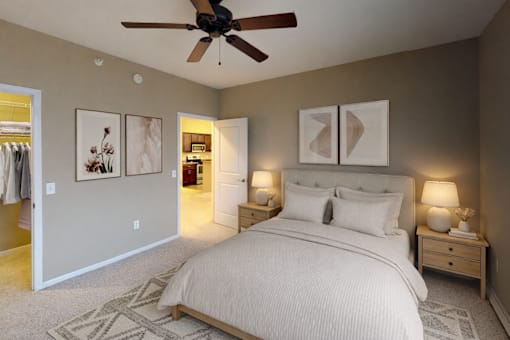 Spacious bedroom with ceiling fan and neutral decor at The Ponds at Heritage Place Apartments, Sartell, MN