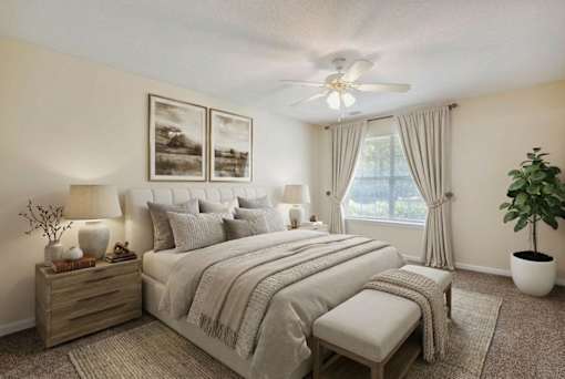 A bedroom with a bed, nightstands, and a ceiling fan.
