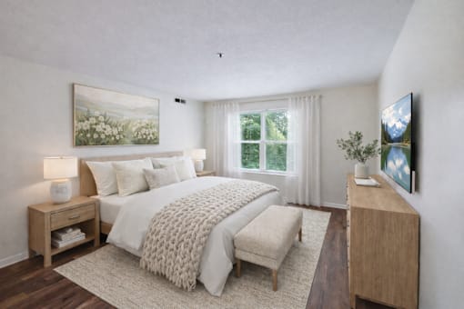 A bedroom with a large bed, a bench, and a painting on the wall.
