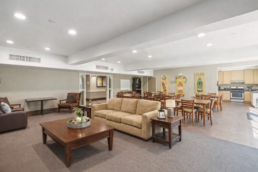 A living room with a brown sofa and a wooden coffee table.