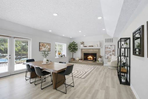 A modern dining room with a fireplace and a large table.