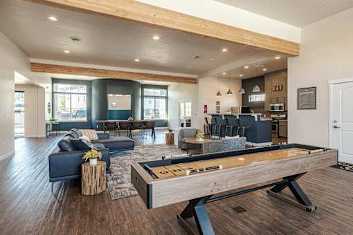 A billiard table is in the middle of a modern living room.