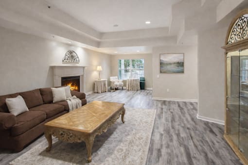 A living room with a brown couch and a wooden coffee table.