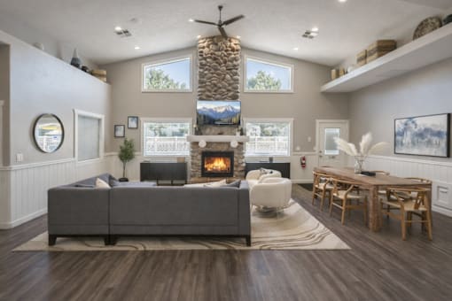 A modern living room with a grey sofa and a fireplace.