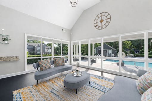 Clubhouse lounge with vaulted ceiling and pool view at Delta Crossing Apartments, North Carolina