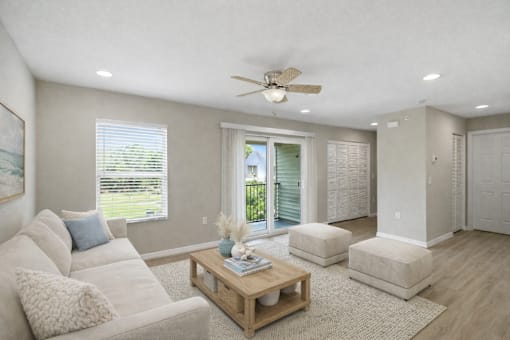 A living room with a white couch and a wooden coffee table.