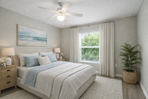 A bedroom with a large bed and a ceiling fan.