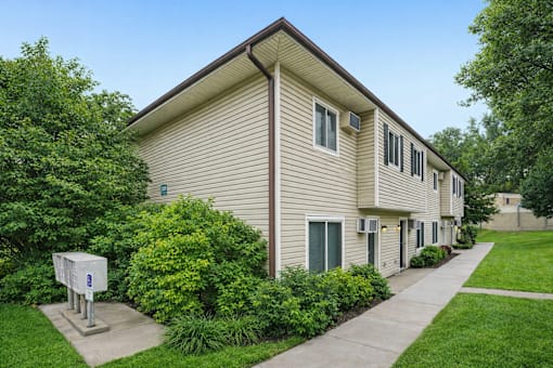 Two story residential building with beige siding at Carver Ridge Townhomes Apartments, Chaska, Minnesota