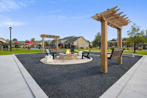 A park with a fire pit and seating area.