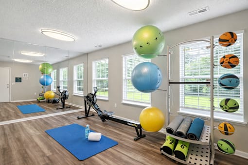 A gym with exercise balls and mats.