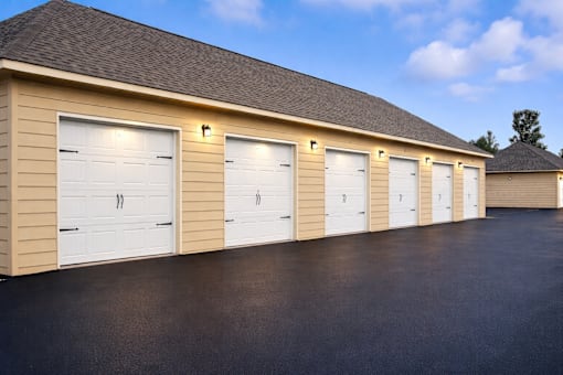 A row of white garage doors are closed.