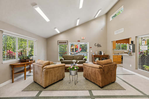 A living room with a brown couch and a coffee table.