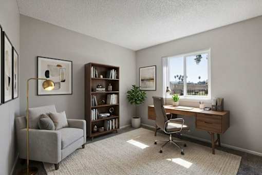 A room with a desk, chair, couch, and bookshelf.