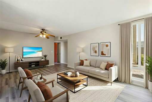A living room with a white couch, a wooden coffee table, and a flat screen TV.