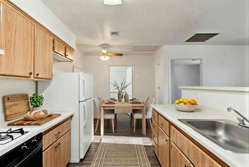 A kitchen with wooden cabinets and a white refrigerator.