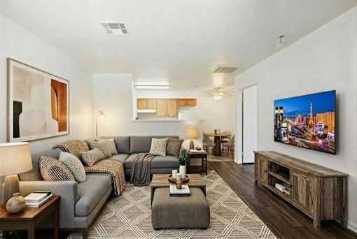 A living room with a grey sofa and a wooden coffee table.