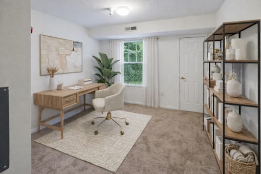 A room with a desk, chair, and shelves with decorative items.