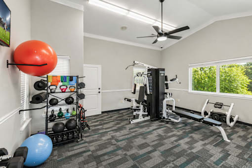 A well-equipped home gym with a variety of exercise equipment.