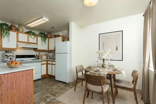 A kitchen with a dining table set for four.