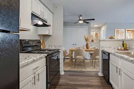 A kitchen with a table and chairs in the middle of it. at Arbors at Hickory Creek Apartments , University Park, IL, 60484