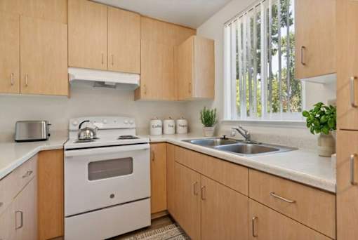 A kitchen with wooden cabinets and white appliances.