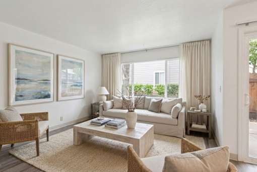 A living room with a sofa, armchair, and coffee table.