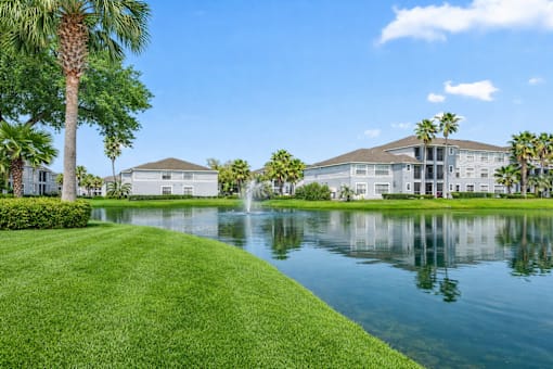 A large house with a fountain in front of it.