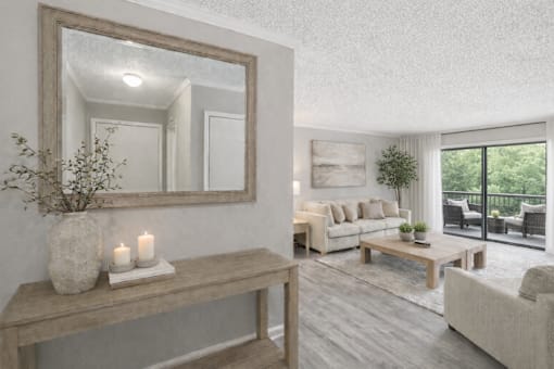 A living room with a large mirror, a wooden bench, and a vase with candles on it.