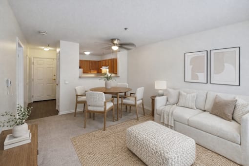 A living room with a dining table and chairs.