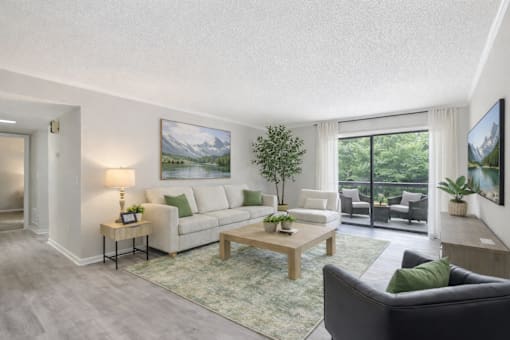 A living room with a couch, a coffee table, and a painting on the wall.